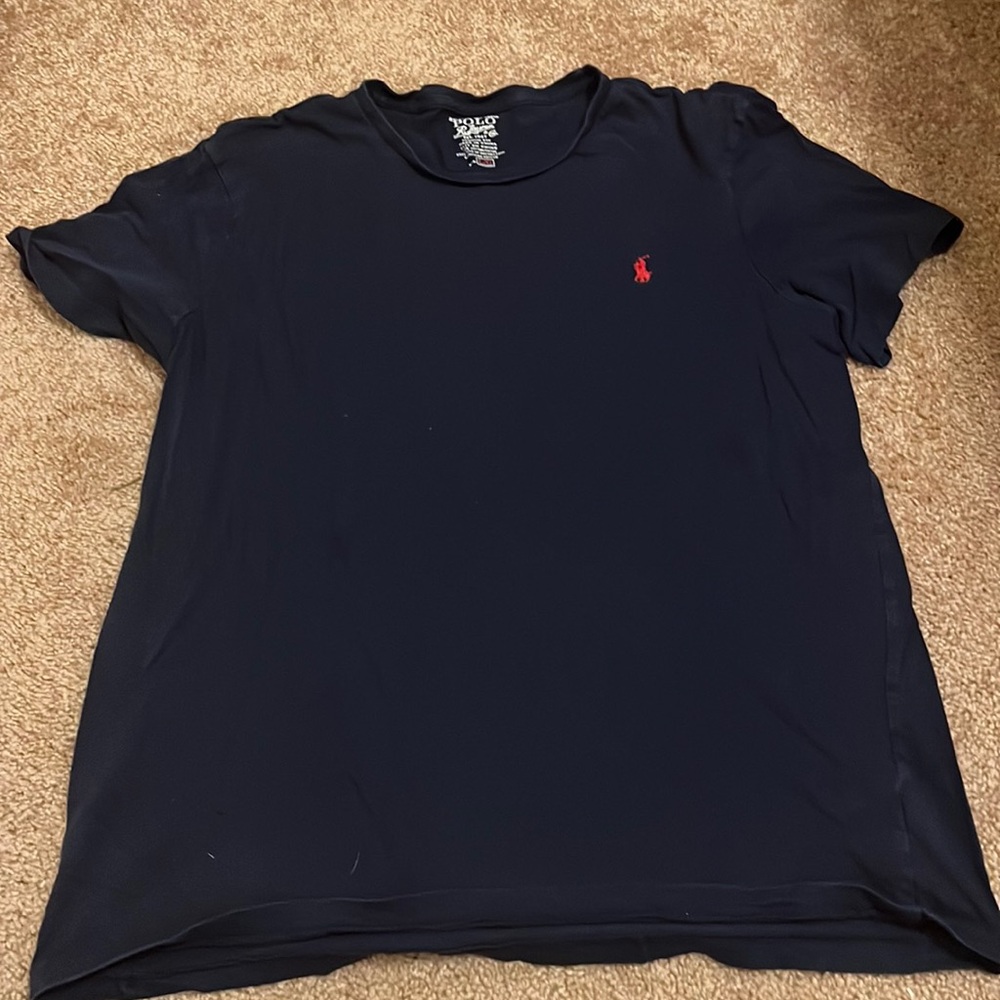Blue polo shirt with red logo.